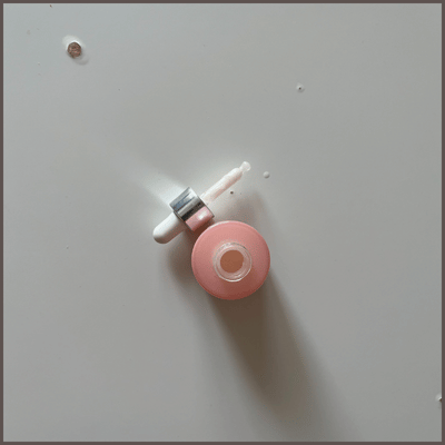 Close-up of hyaluronic acid serum bottle