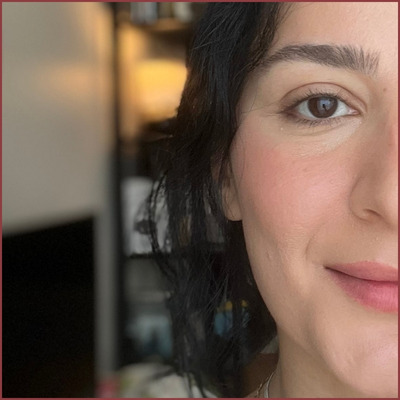 Close-up of me layering powder blush over cheek stain