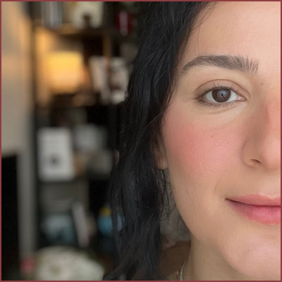 Close-up of me wearing setting powder over blush to make it last longer