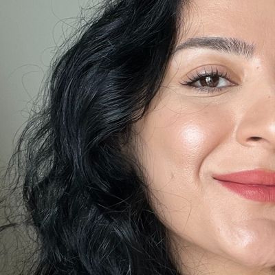 Close-up of the same side of iclal's face after blending in the purple color corrector, showing a brighter, more even-toned complexion